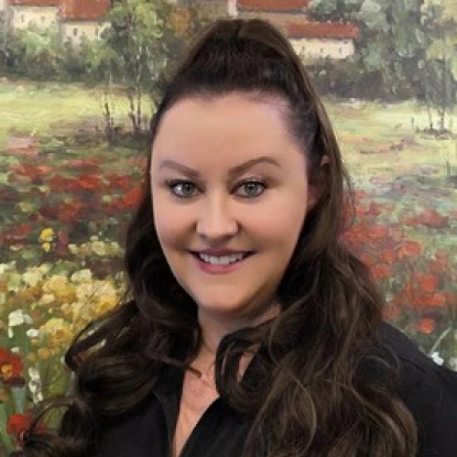 Woman smiling at camera with flower garden background for Riverside Dental website